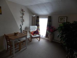 a dining room with a table and a chair and a window at Victorian Townhouse in Banbury