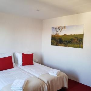 a bedroom with a bed and a painting on the wall at B&b Broodhuis Kerkrade in Kerkrade