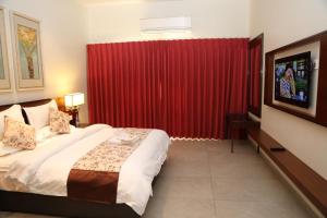 Säng eller sängar i ett rum på Hotel Moon Palace Kolwezi