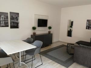 A television and/or entertainment centre at Óvár Apartman