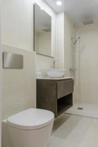 Łazienka z białą toaletą i umywalką w obiekcie APG Plaça Catalunya w mieście Girona