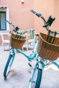 a blue bike with baskets parked in a room at Scene Suites Apartments in Catania