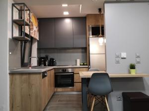 a kitchen with wooden cabinets and a counter top at Apartment 22 in Alexandroupoli