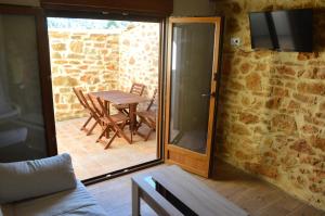 a sliding glass door leading to a patio with a table at Casa Cerrito in Cortes de Arenoso