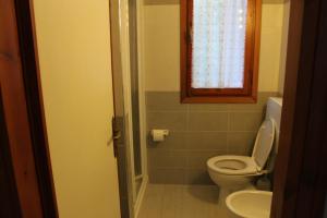 a bathroom with a toilet and a sink and a window at Casa Matilde in Capoliveri +44 photos