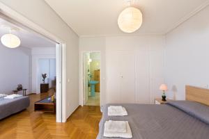a bedroom with a bed and a living room at Christina's flat in Athens +16 photos