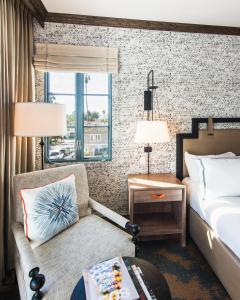 a hotel room with a bed and a couch at Harbor View Inn in Santa Barbara +39 photos