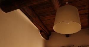 a lamp hanging from the ceiling of a room at La Maison in Bergamo