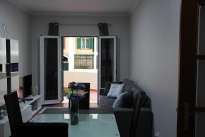 a living room with a vase of flowers on a table at Doca do Cavacas Apartment in Funchal