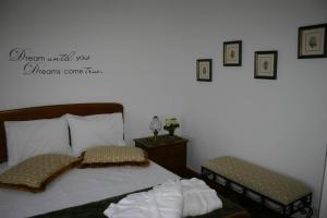 a bedroom with a bed and two stools in it at Quinta das Murtinheiras in Lamego