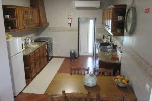 a kitchen with a table with a bowl of fruit on it at Quinta das Murtinheiras in Lamego