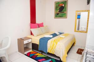 a small bedroom with a bed and a mirror at Conforto Total - Família Mangas Monteiro in Macapá