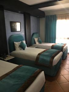 Postel nebo postele na pokoji v ubytování Hotel Al Khaima + 37 fotografií