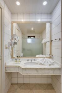 bagno con grande lavandino e specchio di Kuster Hotel a Guarapuava