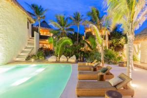 a resort pool with chaise lounges and palm trees at Hotel Ma'xanab Tulum in Tulum +133 photos