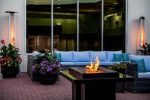 a fire pit in a lobby with a couch and flowers at Red Deer Resort & Casino in Red Deer