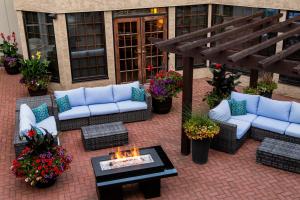 an outdoor patio with couches and a fire pit at Red Deer Resort & Casino in Red Deer