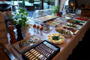 a table topped with lots of different types of food at Hotel Opole Centrum in Opole