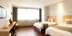 Rúm í herbergi á Unipark by Oro Verde Hotels