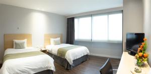 Rúm í herbergi á Unipark by Oro Verde Hotels