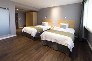 Rúm í herbergi á Unipark by Oro Verde Hotels