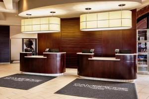 a hotel lobby with a reception desk and chandeliers at Red Deer Resort & Casino in Red Deer