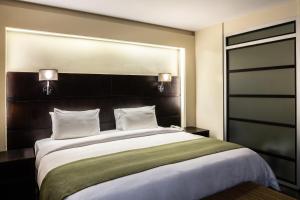 Rúm í herbergi á Unipark by Oro Verde Hotels