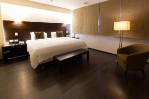Rúm í herbergi á Unipark by Oro Verde Hotels