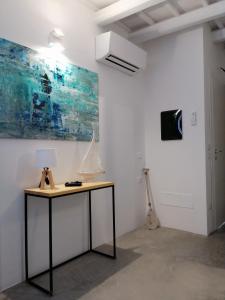 a room with a desk with a lamp and a painting at B&B Sea Salt in Terrasini +71 photos