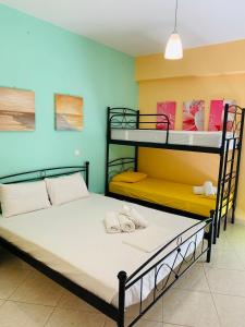 a bedroom with two bunk beds with towels on them at Schoinaria Bay in Damnoni