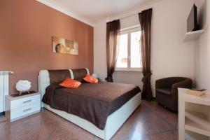 ein Schlafzimmer mit einem Bett, einem Stuhl und einem Fenster in der Unterkunft Dream House spazioso appartamento tra Policlinico e Piazza Bologna in Rom
