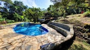 a small pool with a tree in the middle of a yard at La Luciole Ecolodge in Paraty