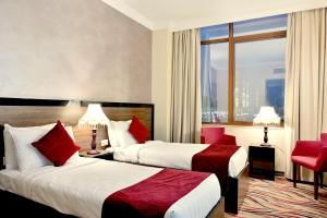 a hotel room with two beds and a window at Hayah Golden Hotel in Medina