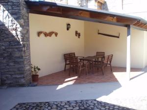 a patio with a table and chairs on it at Cal Reus in Ger