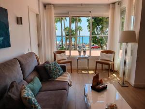 a living room with a couch and a table at Piso Paseo Marítimo in Benalmádena