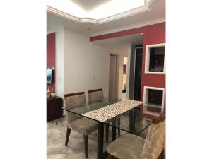 a dining room with a glass table and chairs at FORTE DA PRAIA 2 in Cabo Frio +7 photos