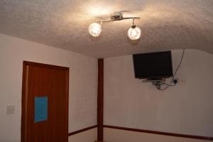 a room with a flat screen tv and a ceiling at BLACKPOOL MERCY Inn HOTEL in Blackpool