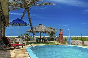 a swimming pool with a view of the ocean at Pousada Por do Sol in Barra Nova