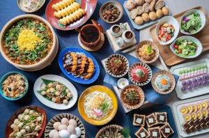 a table topped with lots of different dishes of food at Vessel Hotel Campana Nagoya in Nagoya