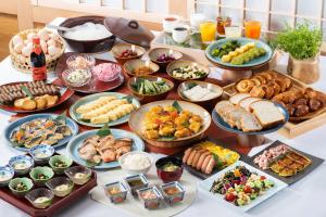 a table topped with lots of different types of food at Vessel Hotel Campana Kyoto Gojo in Kyoto