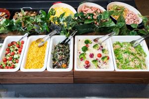 a table with four trays of different types of food at Vessel Hotel Campana Kyoto Gojo in Kyoto