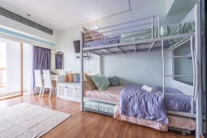 a bedroom with two bunk beds and a desk at Exclusive Family Suites @ Sunway Pyramid Resort in Petaling Jaya