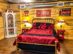 a coca cola bedroom with a bed and two tables at Samantha's Timber Inn in Murfreesboro