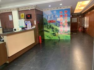 a restaurant with a sign on the wall in a building at Yi Dian Yuan Hotel in Zhongli