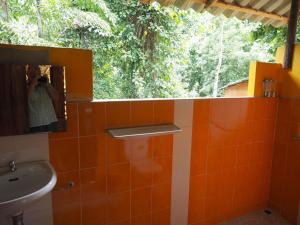a bathroom with a sink and a mirror and trees at LITTLE EDEN Bungalows in Ko Chang