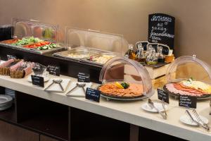 a buffet with different types of food on a table at Baikal Business Center Hotel in Irkutsk