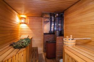 an empty sauna with a bench and a stove at Sheregesh's Wood Chalets & Apartments in Sheregesh