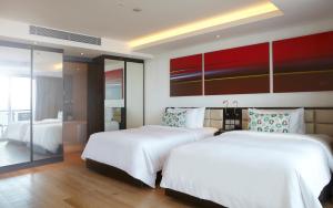 a hotel room with two beds and a window at Double - Six, Luxury Hotel - Seminyak in Seminyak