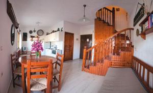 a kitchen and dining room with a table and a staircase at Villa Michalis in Istro