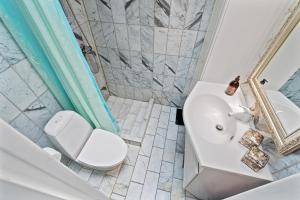 a bathroom with a white toilet and a sink at rækkehus ved amagerstrand in Copenhagen